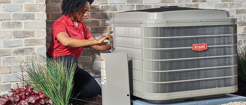 48279-SR-Aug2019 HVAC repair technician servicing an air conditioner