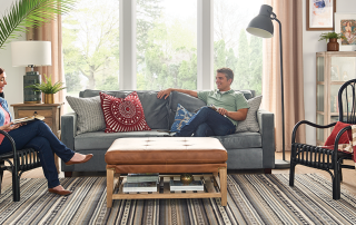 Woman and husband enjoy dehumidifier benefits as they lounge in their homey living room.