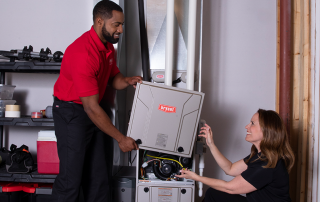 Two technicians replace your furnace in homeowner's basement.