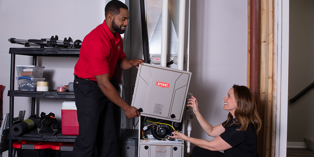 Two technicians replace your furnace in homeowner's basement.