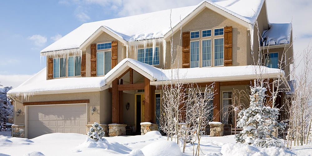 House with snowy roof goes through steps for winterizing your home.